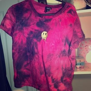 A size M crop top with a uncanny smiling face